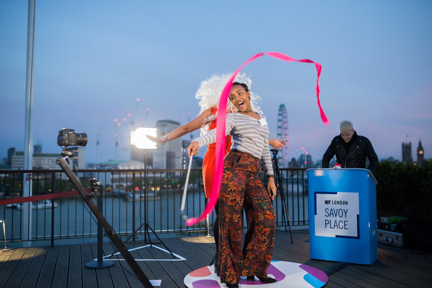 Guests using a 360 photo booth on the Savoy Place terrace overlooking London