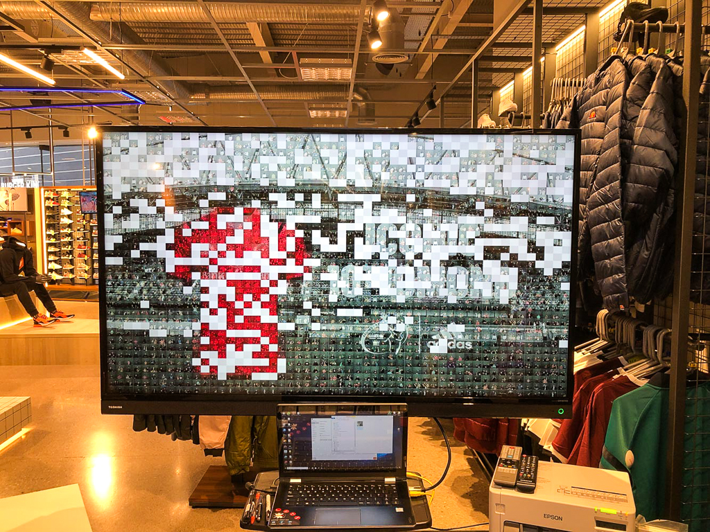 Completed photo mosaic wall assembled from individual guest photographs — photo mosaic wall hire