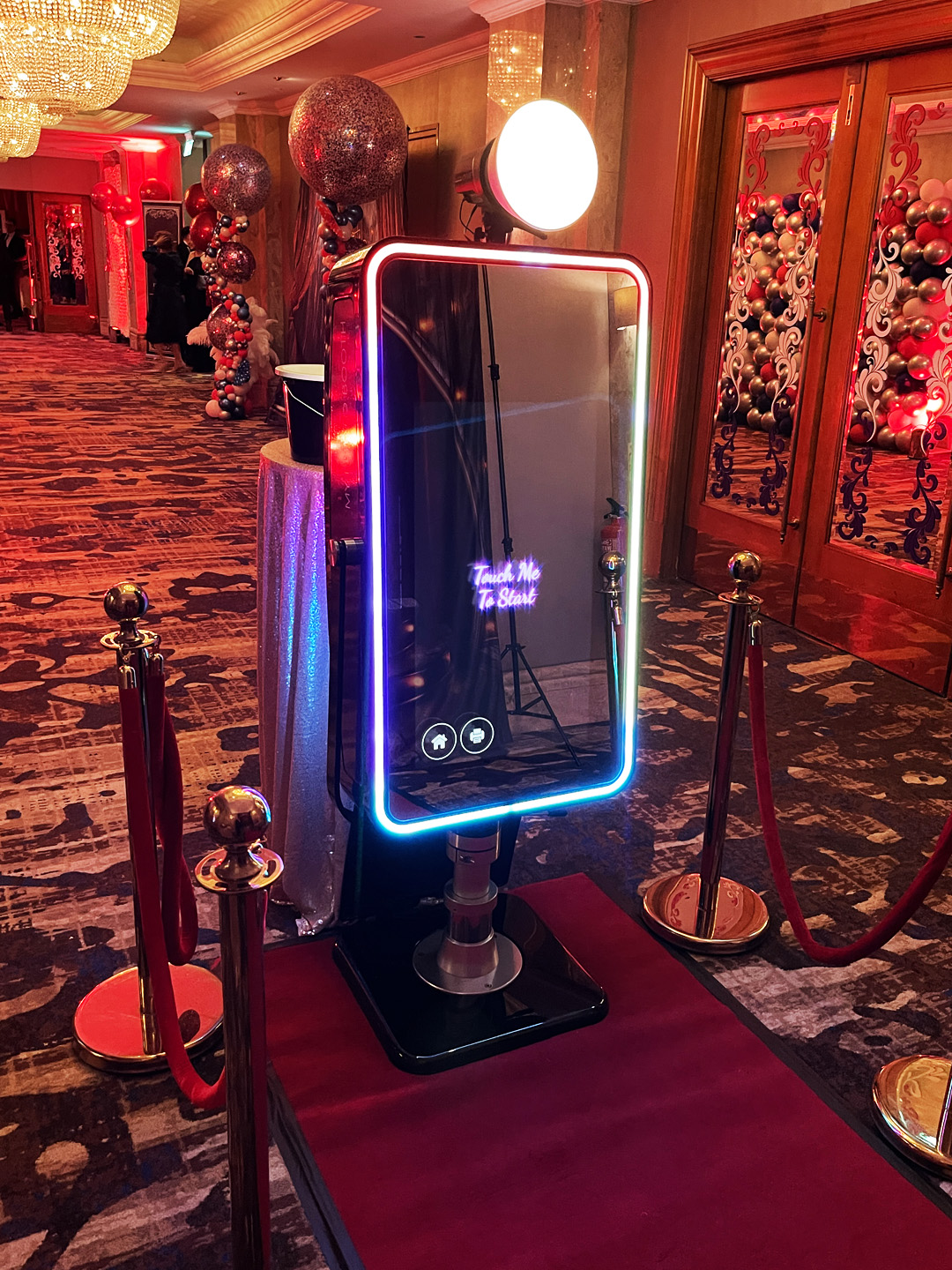 Fusion Mirror Booth with an illuminated frame and red carpet at an event
