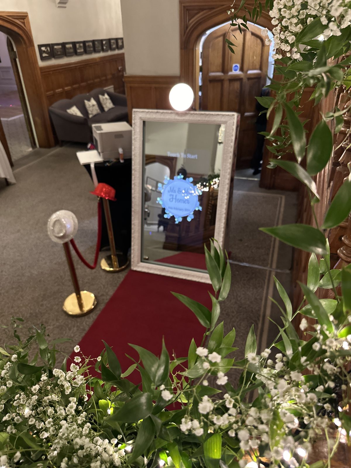 Framed Magic Mirror photo booth with a red carpet at a wedding venue