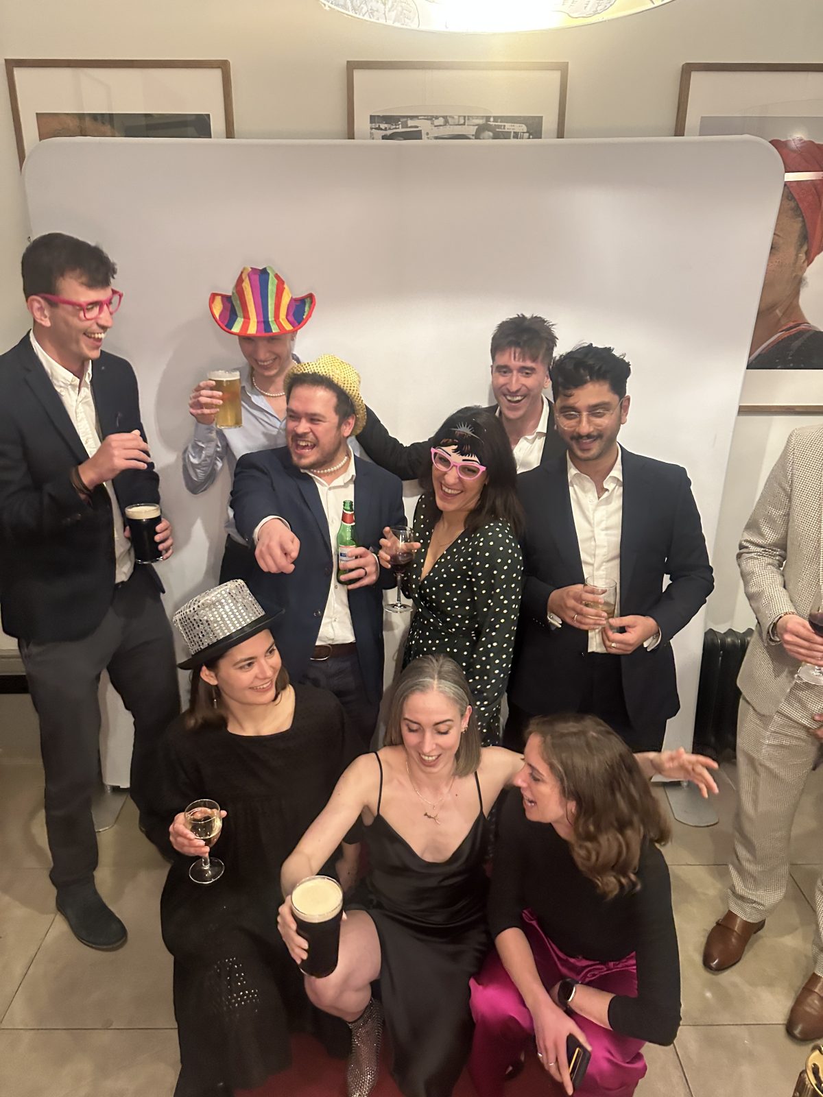 Group of guests laughing and posing with photo booth props