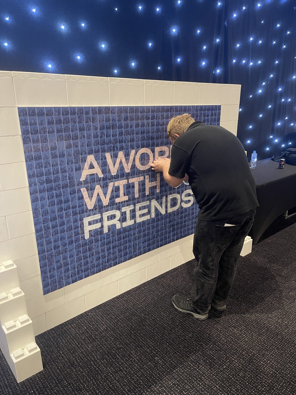 Guest adding a photograph to a World With Friends photo mosaic wall