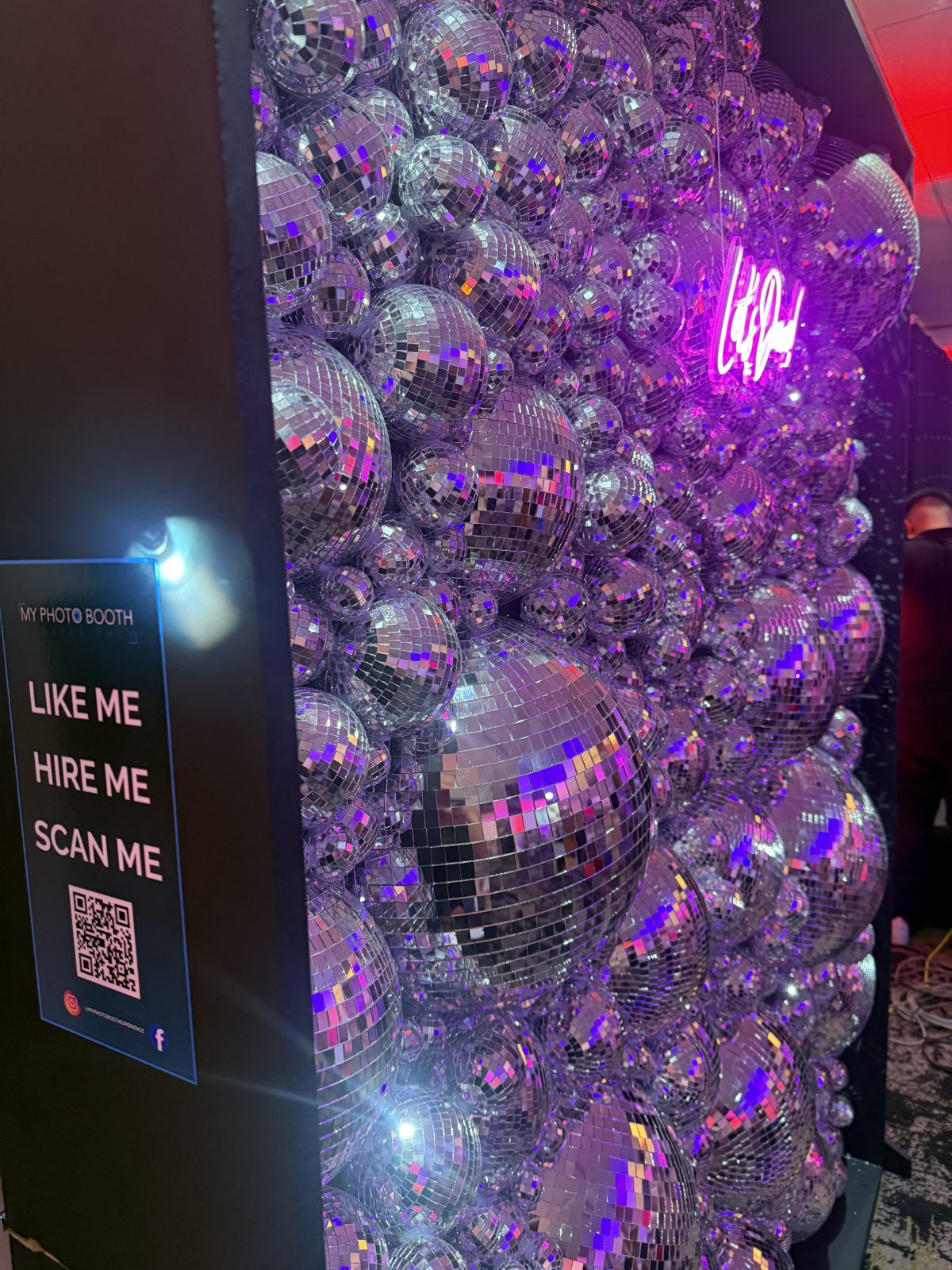 Mirrored Disco Wall with pink lighting and a neon sign