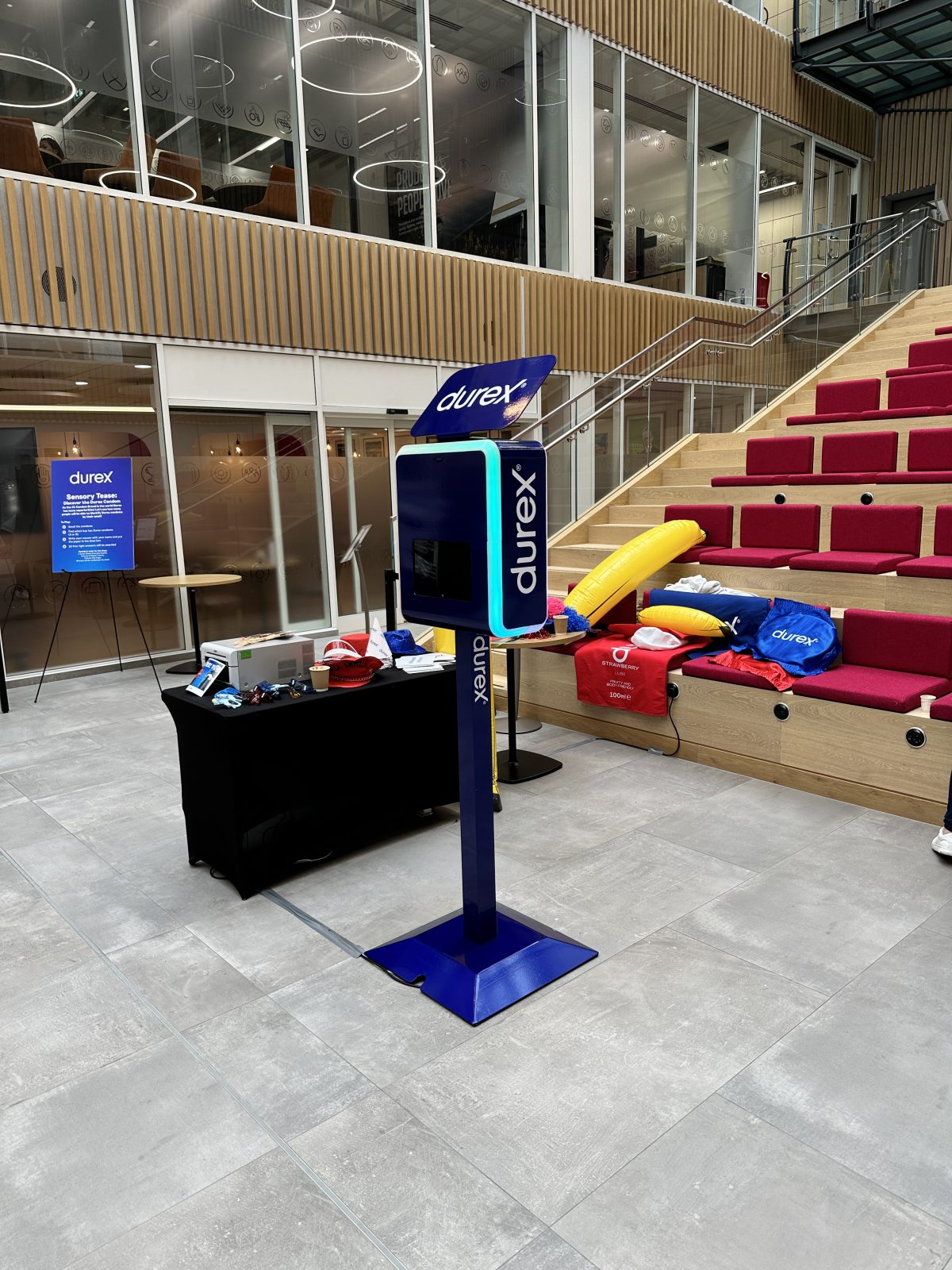 Photo booth display with props and blue branded panels at an exhibition